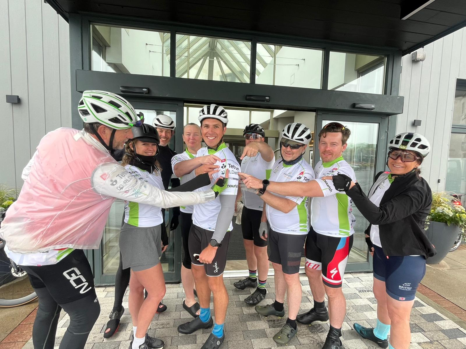Tour de Barchester 2026 cycling team pointing at Teton branding